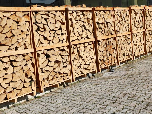 many pallets with cut wood logs used for wood heating stoves