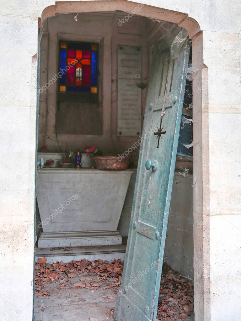 door of an abandoned grave in the cemetery