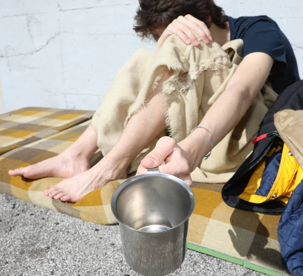 Young Poor Homeless Man Blanket Filthy Mattress Pot Collect Offerings — Stockfoto