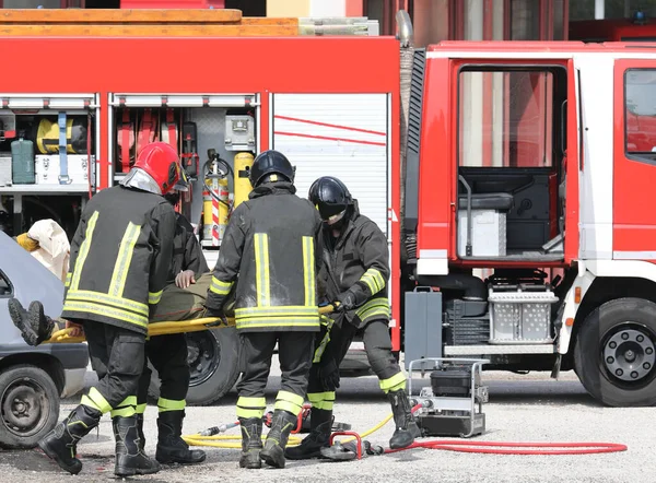 Команда Пожежників Які Несуть Пораненого Чоловіка Ношами Після Дтп Шосе — стокове фото