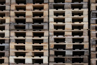 background of wooden pallets piled up in the warehouse of a freight forwarding company without the goods