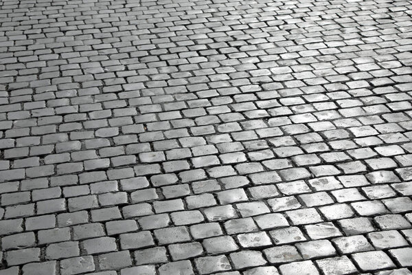 background of many cubic tiles called Sampietrini typical of the pavement of many European squares and especially of St Peter Square in the Vatican
