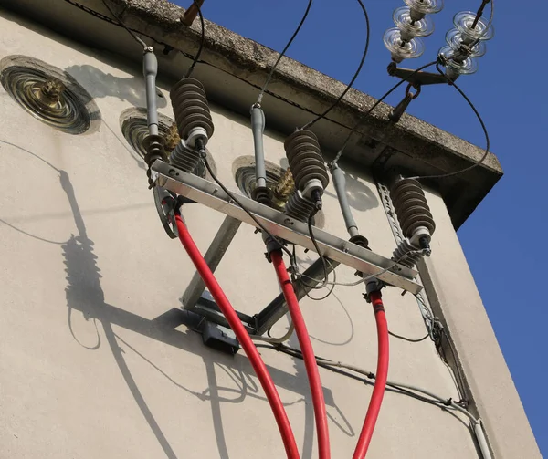 detail of the high voltage electrical red isolated cables in the substation and big insulators