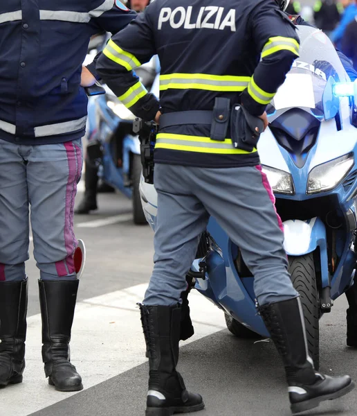 Checkpoint with many policemen and uniform with text POLIZIA that means POLICE in ITALY and the motorbike