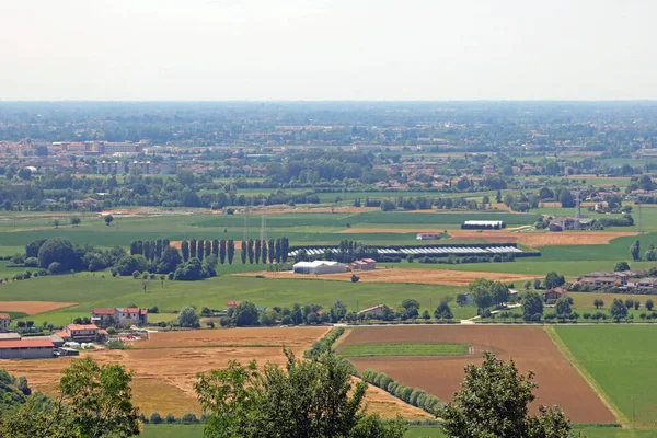 landscape of Wide flatland called Pianura Padana in italian language in Northern Italty with Farm and cultivated fields