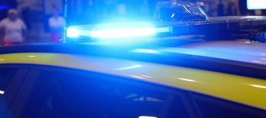 flashing blue of the police car during the protest in the city