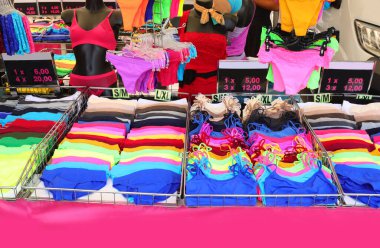 stalls in underwear with panties and bra and underpants and tank tops and very stiff bright colors at the local market