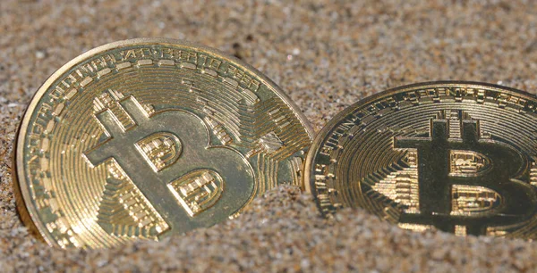 Bitcoin cryptocurrency mining process that unearthed two large golden coins with the capital letter B