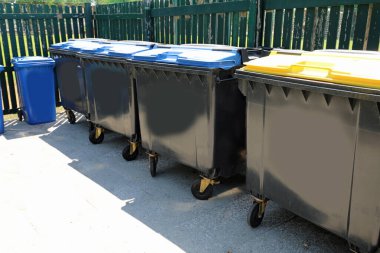 Many plastic boxes for the separate collection of waste in the area dedicated to garbage management