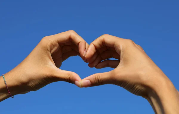 Two Joined Hands Person Forming Big Heart Blue Sky Background Stock Photo