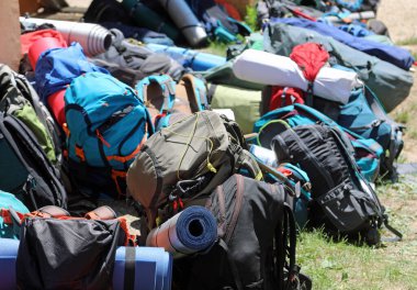 pile of many backpacks used by young travelers during traveling camping around the world