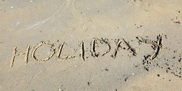 Large Text Word Holiday Capital Letters Sand Sandy Beach — Stock Photo, Image