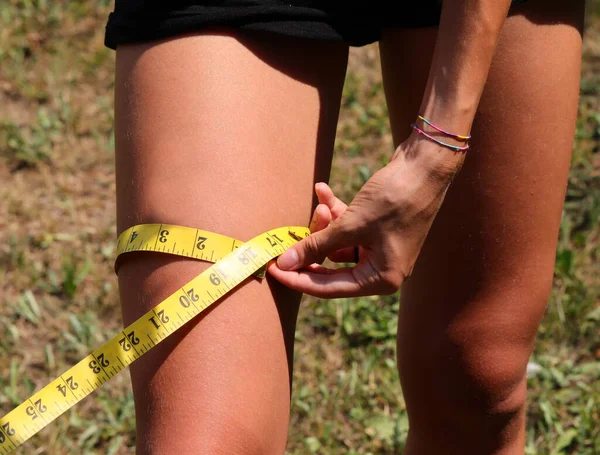Young Slender Girl Teenager Measuring Her Leg Thigh Weight Loss — Stockfoto