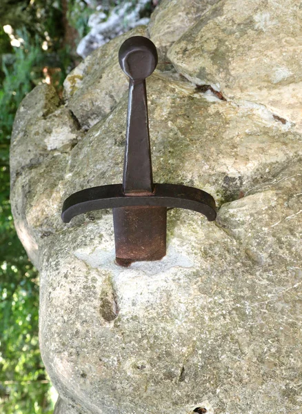 big sword in the stone symbol of the famous legend of King Arthur that only he will be able to extract