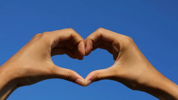 Two Joined Hands Forming Heart Blue Sky Background — Fotografia de Stock