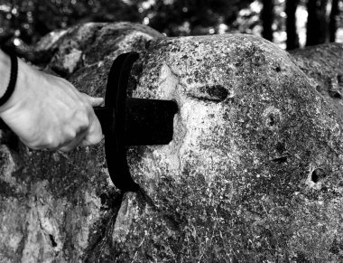 hand of knight and sword in the stone as in the legend of King Arthur
