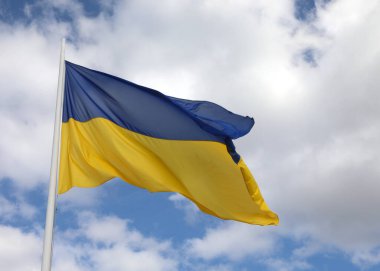 flag of Ukraine with blue sky and white clouds