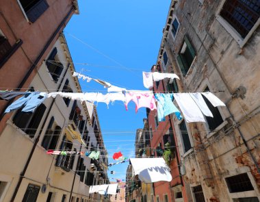 many clothes hanging out in the sun to dry on a sunny day in the European city