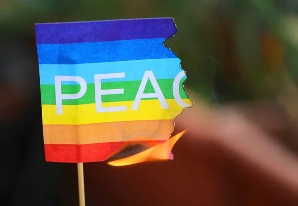 Multicolored Flag Text Peace Burning Because War — ストック写真