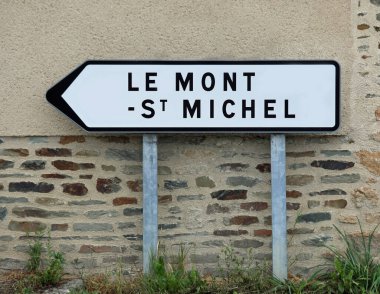 road sign with arrow indicating the locality Le Mont Saint Michel in Normandy France