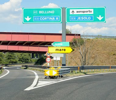motorway junction with names of the places in Italian and directions to go to the Venice airport text MARE means SEA in Italy
