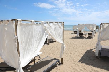 gazebos for sheltering from the sun with deckchairs in the exclusive resort by the sea in summer