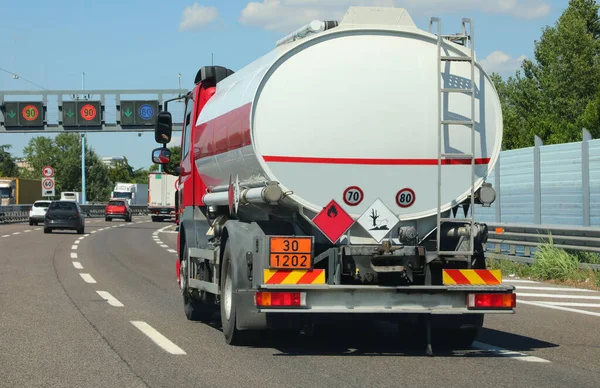 large tanker truck in the busy street for transporting flammable material