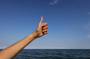 hand with thumb up pointing up ok sign all right and success