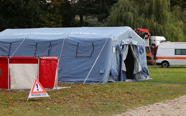 camp equipped with a blue tent and warning signs and the text in Italian which means CIVIL PROTECTION