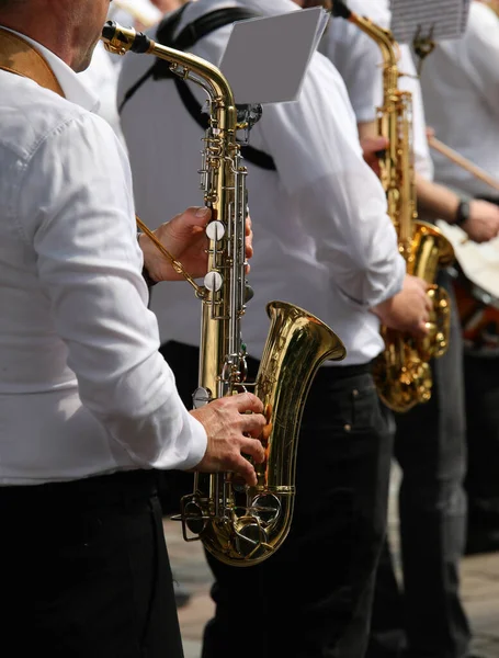 saxophonists of the musical band during the singing event in the town square