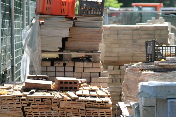 materials for the construction and maintenance of buildings in a construction site warehouse