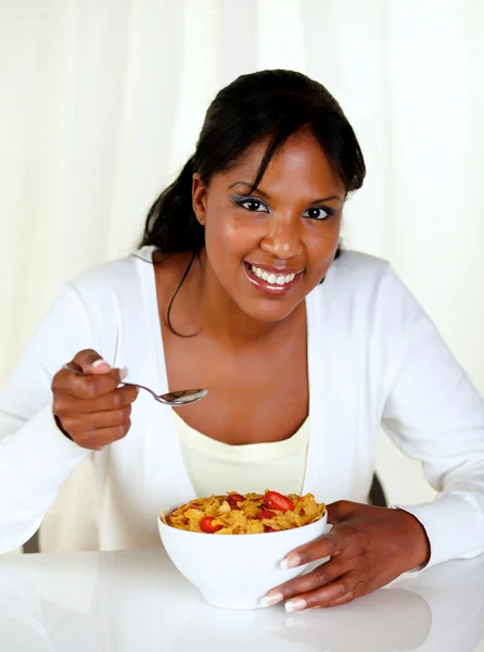 Young lady smiling at you and having breakfast — Stock Photo, Image