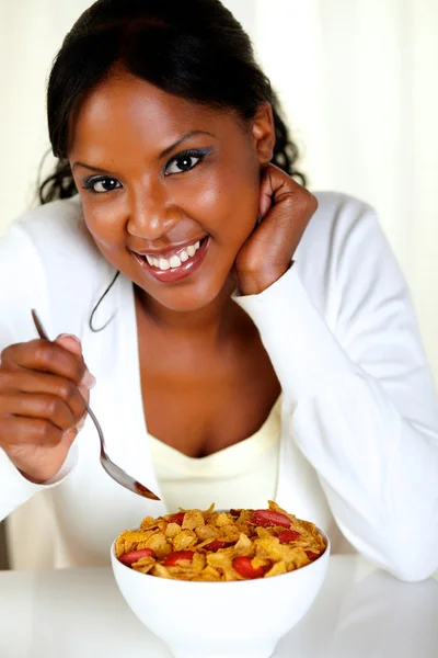 Relaxed woman looking at you having breakfast — Stock Photo, Image