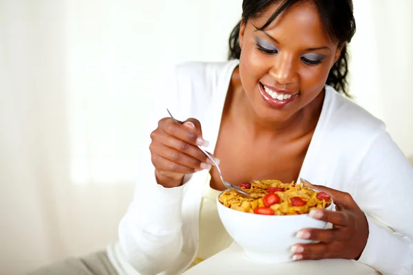 Smiling afro-american woman having breakfast Stock Image