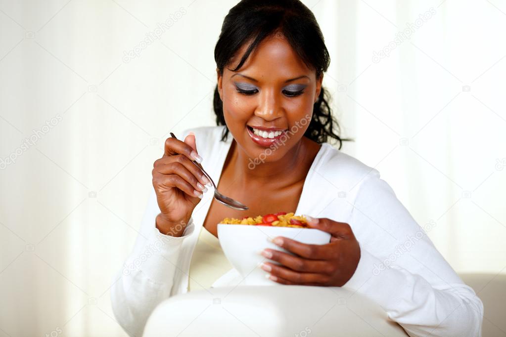 Young black woman having healthy breakfast