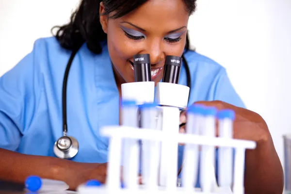 Medical doctor female working with a microscope — Stock Photo, Image