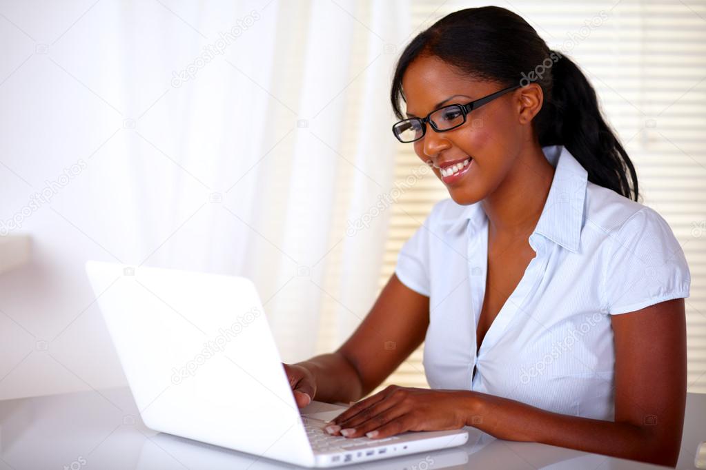 Stylish young woman working on laptop