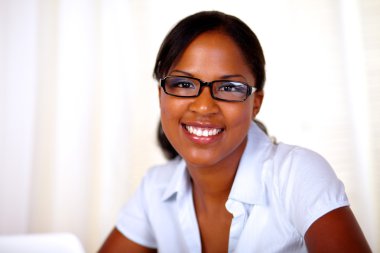 Attractive young woman looking and smiling at you