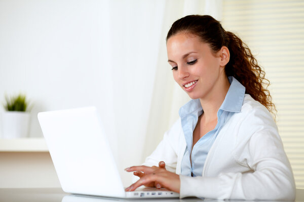 Adult pretty woman working on laptop