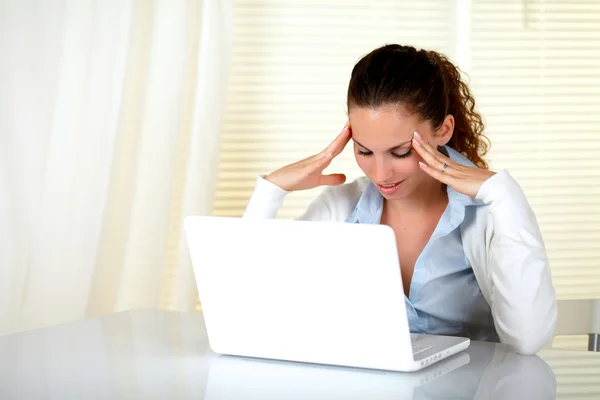 Reflective woman working on her laptop Stock Image