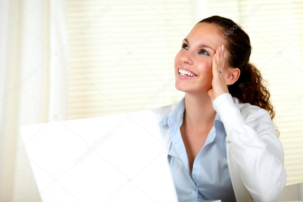 Smiling young woman looking up