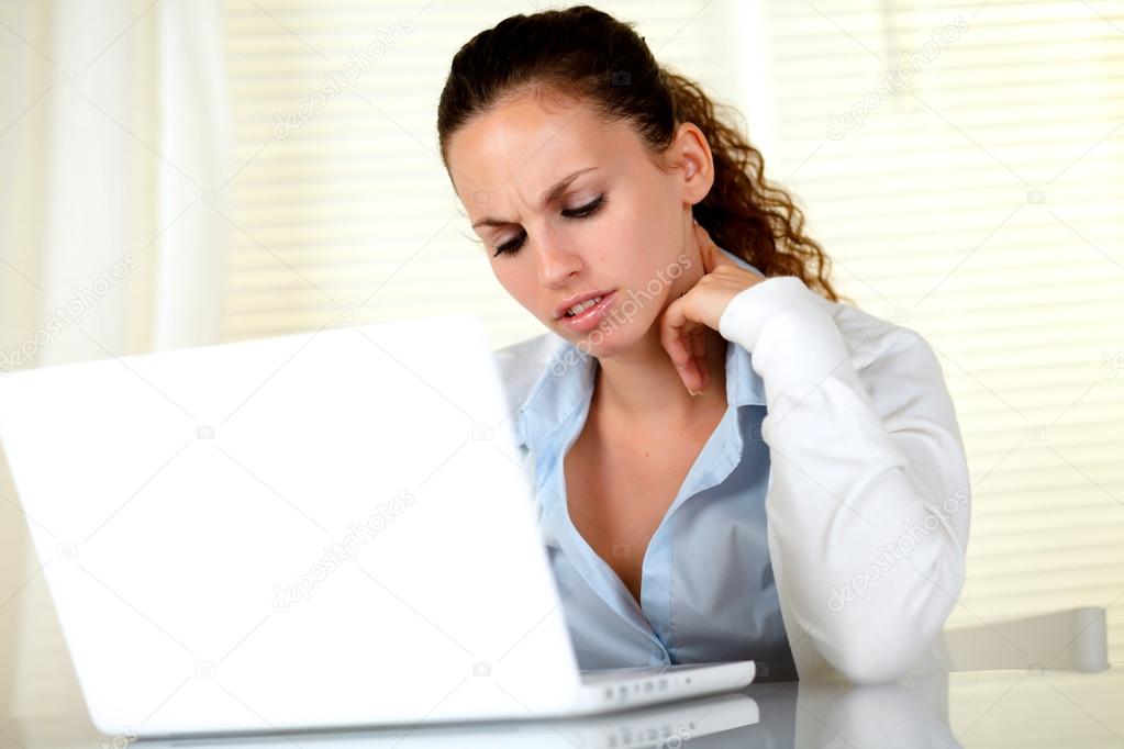Young woman interested reading the laptop screen