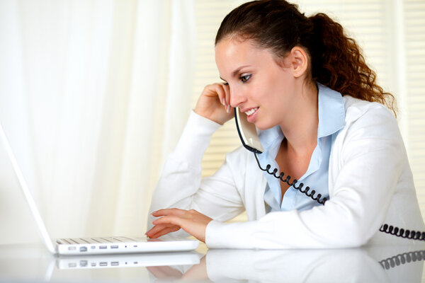 Lovely woman browsing the internet on her laptop