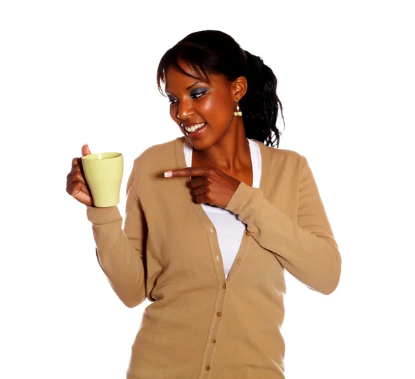 Pretty young woman pointing a mug — Stock Photo, Image
