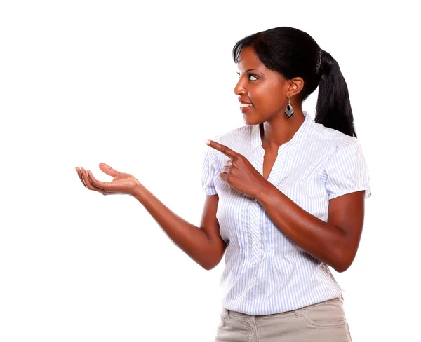 Adult woman looking and pointing to her right — Stock Photo, Image