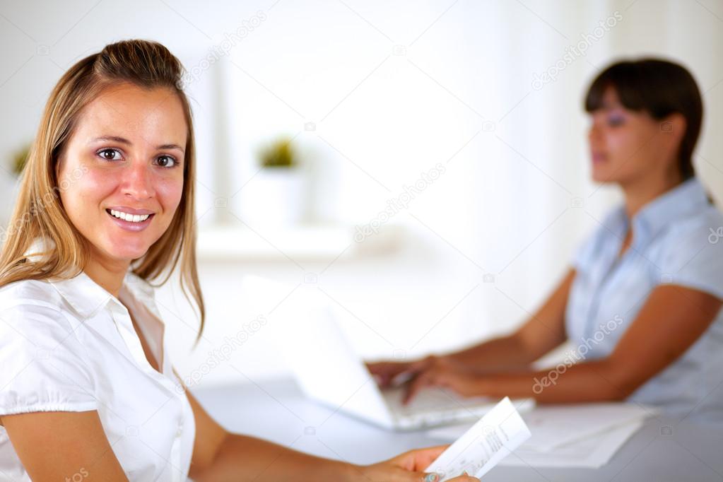 Caucasian businesswoman smiling and looking at you