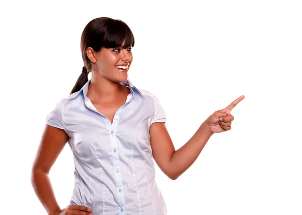 Latin young woman looking and pointing her left — Stock Photo, Image