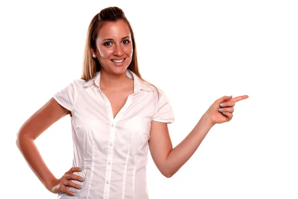 Charming blonde young woman pointing to her left — Stock Photo, Image