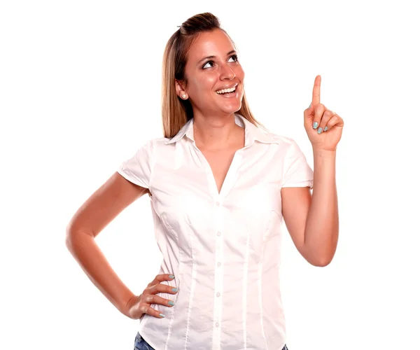 Smiling young woman looking and pointing up — Stock Photo, Image