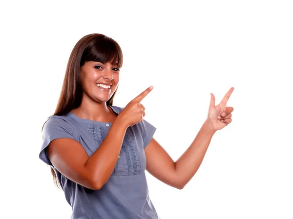 Stylish young woman looking at you and pointing up — Stock Photo, Image